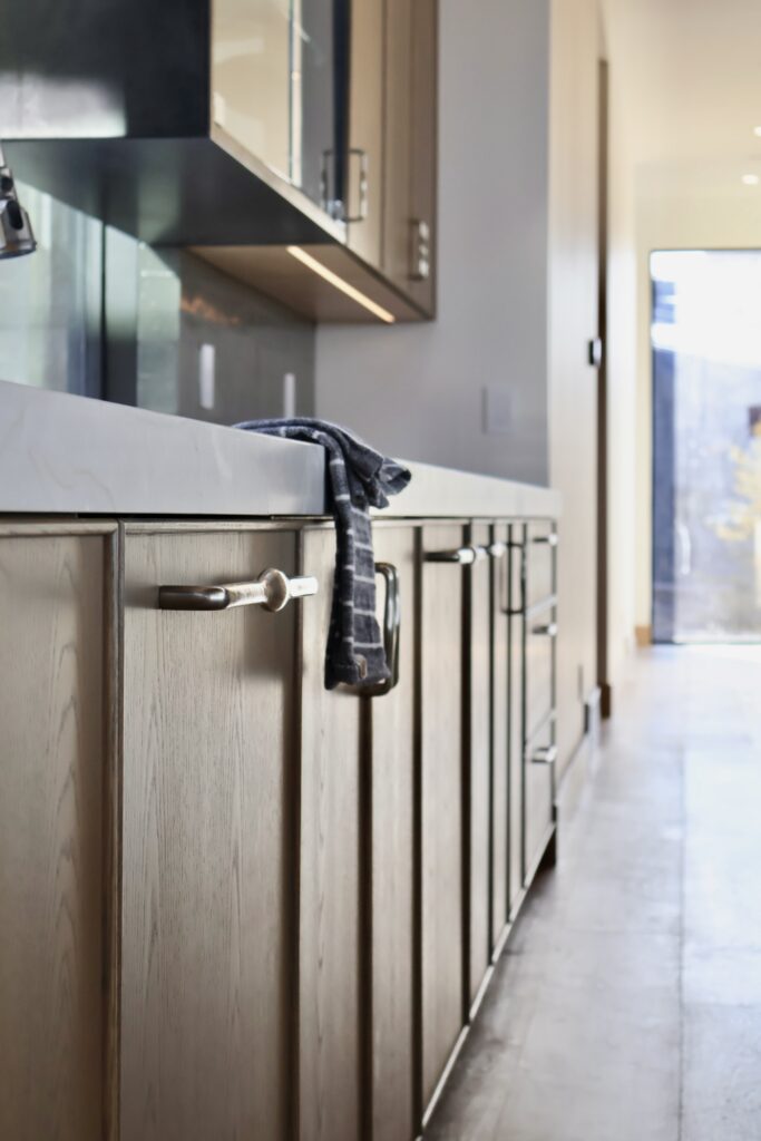 European cabinet hardware, integrated handles on European cabinets, Gola cabinet handles, flat panel cabinet hardware, wood veneer cabinet pulls, Shaker cabinet hardware, slim Shaker cabinet hardware, custom cabinet hardware, modern European kitchen hardware, White oak veneer with beaded outside edge, custom stained, frameless style. Custom 5-piece door.