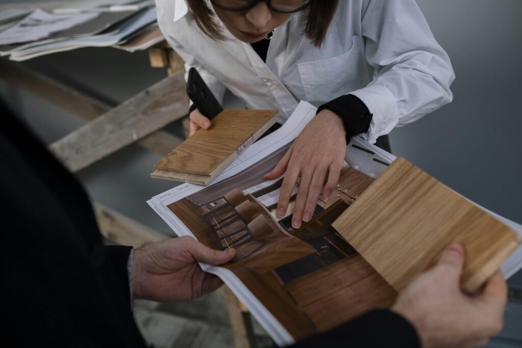 On-site collaboration photo: designer, builder, or installer reviewing cabinetry plans or installation.