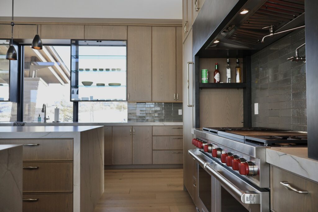 fully custom cabinets in luxury home, custom cabinetry design, luxury custom kitchen cabinets, fully custom European cabinetry, custom cabinet storage, custom cabinet interior, custom pantry cabinets, luxury cabinetry materials, custom built-in cabinets, White oak veneer with beaded outside edge, custom stained, frameless style. Integrated panel-ready appliances.