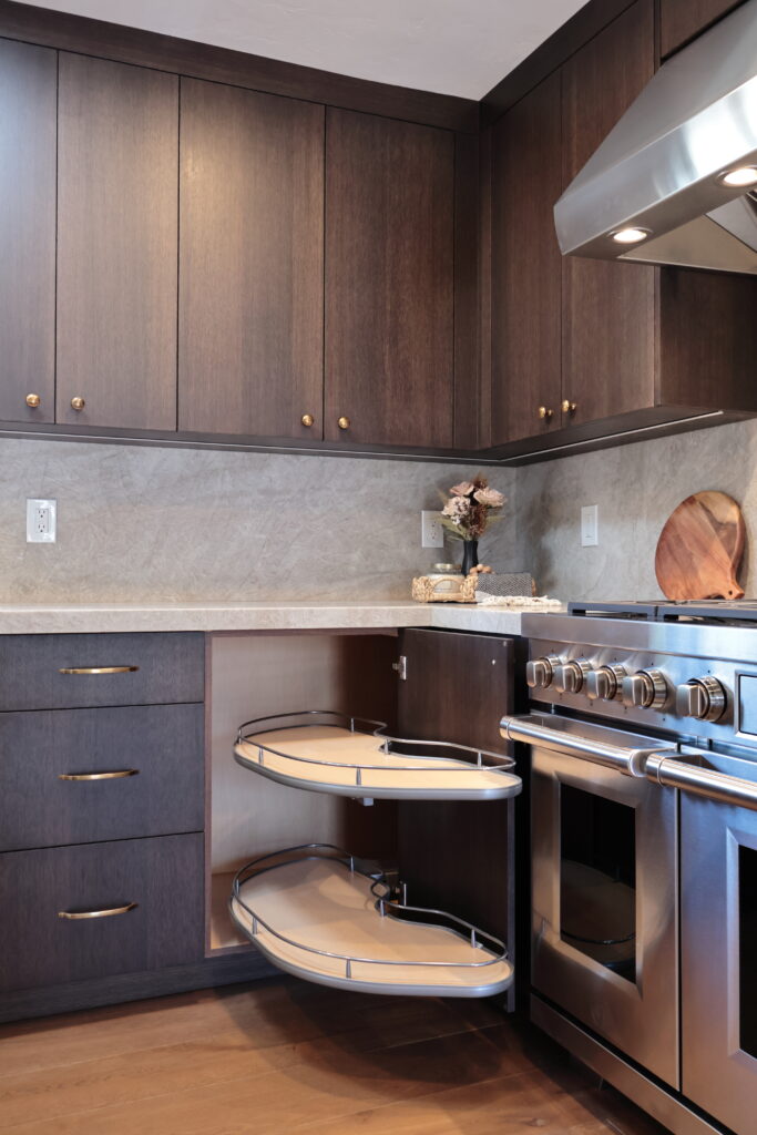 frameless cabinets, European cabinetry kitchen, frameless cabinet construction, European style cabinets, custom frameless kitchen, luxury frameless cabinets, frameless cabinet interior, European kitchen cabinetry, linen closet, built-in cabinets, hallway cabinet, hallway storage, custom stained rift white oak, kitchen cabinets, designer kitchen with custom cabinetry, finish custom cabinets color matched to interior design, luxury kitchen with deep wood tone cabinetry, custom home construction, kitchen cabinetry detail, Euromax custom cabinets, close-up finish detail, storage solution, pull out drawer for storage, built-in storage